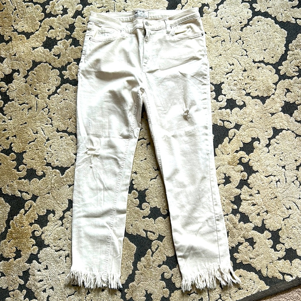 Free People cream colored jeans with fringed bottoms. NWOT size W30.